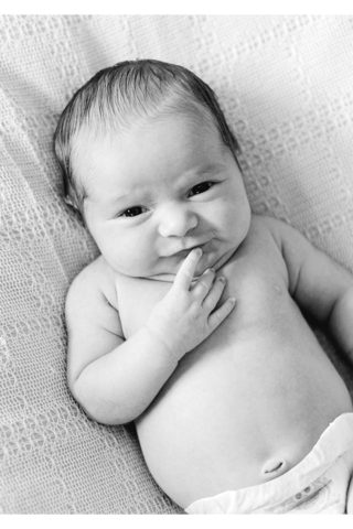 Black and white newborn image of awake baby girl