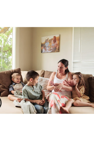 Take it easy with an in-home lifestyle newborn photo session. Easy as the family sitting on the sofa.