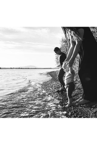 Black and white photo of Mother and two boys down at the riverside